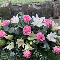 White lily and pink rose casket spray 